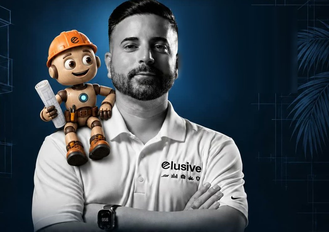 Marcel Reinosa in an Elusive polo, with Hermes — the Elusive robot mascot in an orange hard hat — sitting on his shoulder holding a rolled blueprint