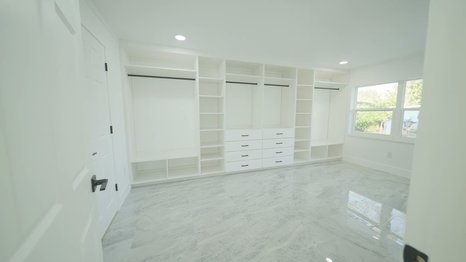 Built-in closet: shelves, hanging space and drawers along the whole wall