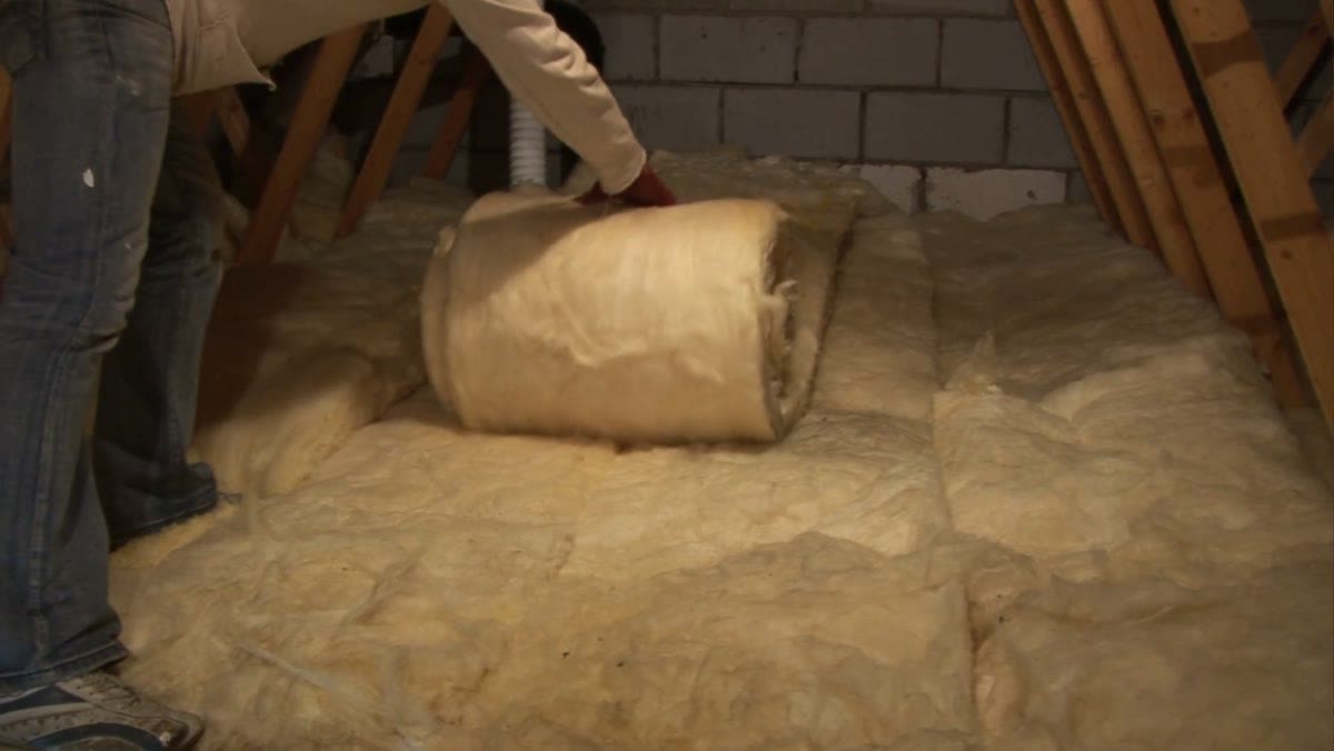 Rolling out attic insulation