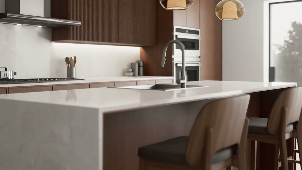 A quartz island with walnut cabinets