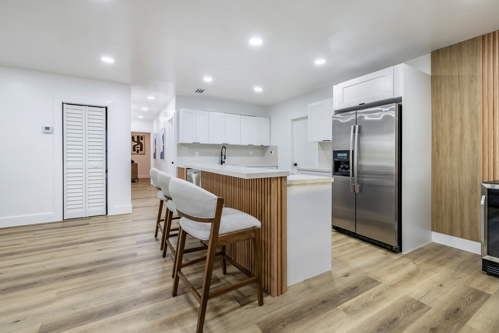 Island seating: quartz counters and bar seating that open the kitchen to the living area