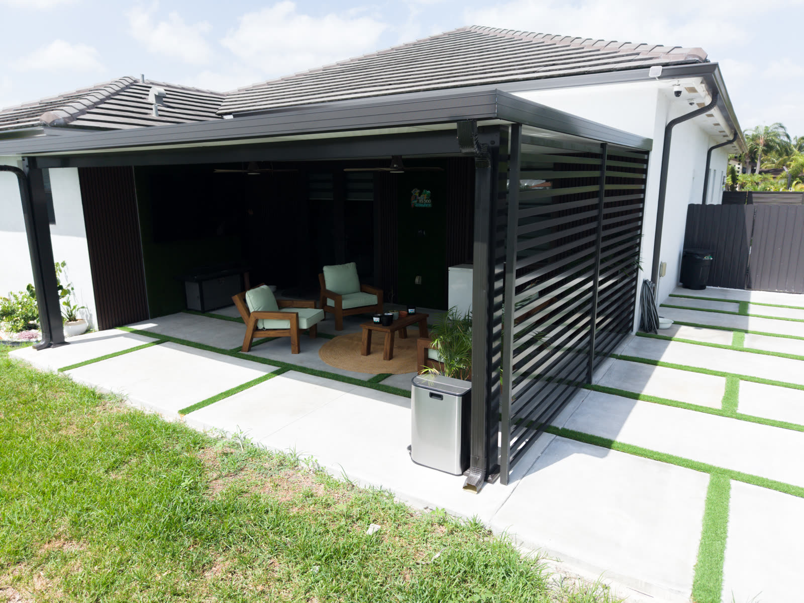 Patio cover: an aluminum roof with a louvered privacy screen and room for outdoor seating